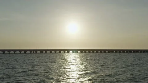 Flight over the ocean during sunset with famous bridge in Puerto Progreso, Stock Footage 190068231