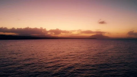 Flight over the ocean to the pink sunset and island beach Stock Footage 101486671