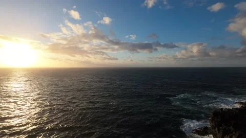 Flight over ocean sunset sun Rocky Coastline Waves Crashing Cliffs Azores Video stock 221565440