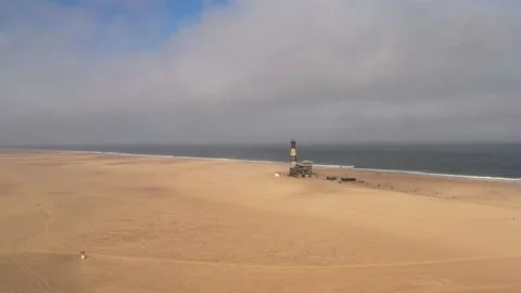 Flight over the oceanfront lighthouse at Sandwich Harbour Video stock 157583774