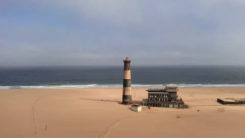 Flight over the oceanfront lighthouse at Sandwich Harbour Video stock 157583888
