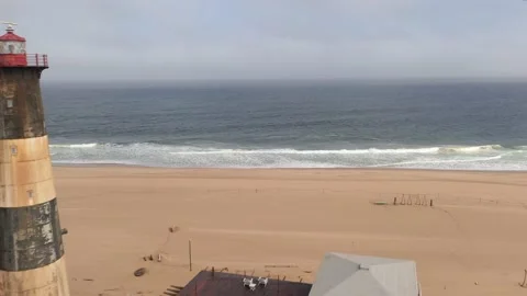 Flight over the oceanfront lighthouse at Sandwich Harbour Video stock 157583944