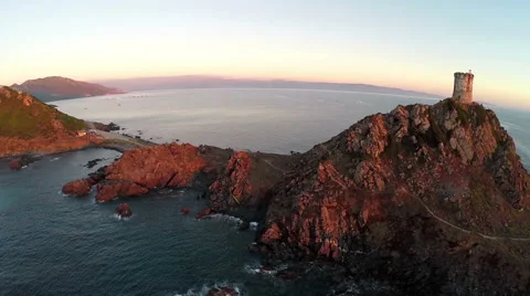 Flight over old tower in the sea at sunset. Ajaccio, Corsica. Aerial view. Vídeo Stock 47477603
