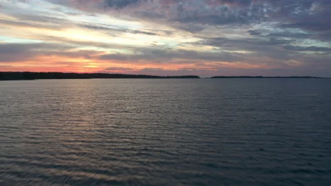 Flight over open water toward horizon during sunset Stock Footage 140411510