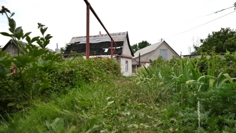 Flight over the path to the cottage in the garden. Slow motion Stock Footage 135172572