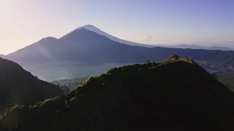 Flight over the peak of Mount Batur with a view of Mount Agung and Lake Batur. Stock Footage 236545926
