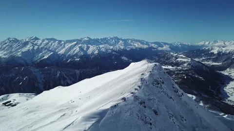 Flight over the peak of a snow-covered mountain Stock Footage 154394374