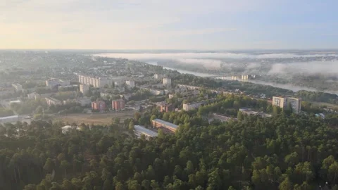 Flight over a pine forest and the city of Aleksin at dawn Stock-Footage 254068948