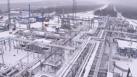 Flight over pipes on winter gas field Vídeo Stock 123764119