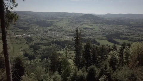 Flight over Plain, forest, village and mountains on a sunny day ungraded Stock Footage 105849436