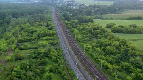 Flight over the railway along which the train moves. Stock Footage 116804633