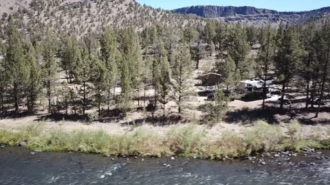 Flight over remote high desert flyfishing stream canyon Stock Footage 95874897