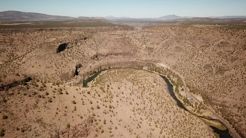 Flight over remote high desert flyfishing stream canyon Stock Footage 95875123