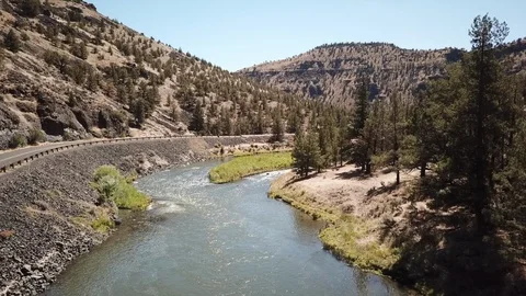 Flight over remote high desert flyfishing stream canyon Stock Footage 95876185