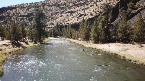 Flight over remote high desert flyfishing stream canyon Stock Footage 95876261