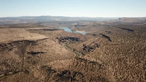 Flight over remote high desert flyfishing stream canyon Stock Footage 95876372