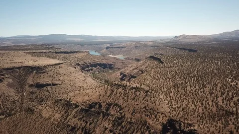 Flight over remote high desert flyfishing stream canyon Stock Footage 95876556