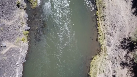 Flight over remote high desert flyfishing stream canyon Stock Footage 95877093