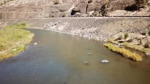 Flight over remote high desert flyfishing stream canyon Stock Footage 95877216