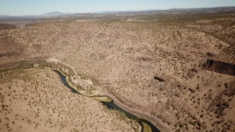 Flight over remote high desert flyfishing stream canyon Stock Footage 95877590