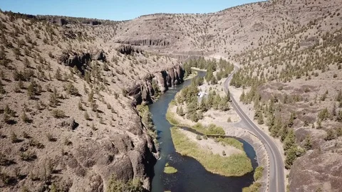 Flight over remote high desert flyfishing stream canyon Stock Footage 95877833