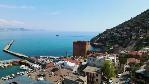 Flight over the resort town, red tower by the sea, port in the Mediterranean Stock Footage 157645330