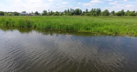 Flight over the river bank, reflection of the sky in the water Stock Footage 90076258