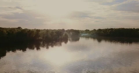 Flight over the river on the beach camping with smoke from cooking. Stock Footage 89681638