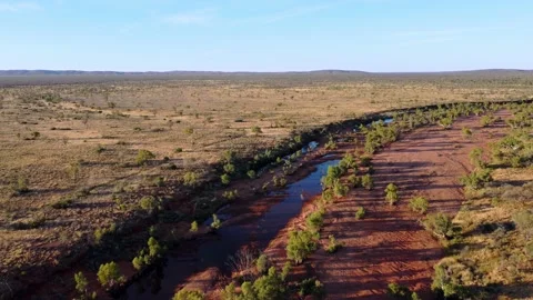 Flight over river bed in central Australia after rain Stock Footage 153973529
