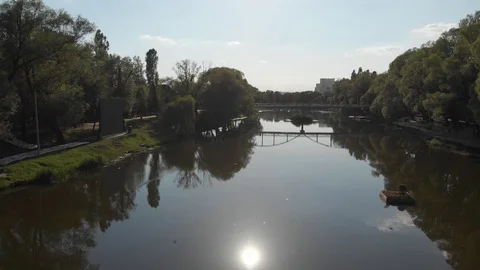 Flight over the river in a city park among trees Stock Footage 91254005