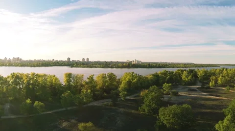 Flight over river coast in sunset time. Aerial landscape with turn Stock Footage 55546087