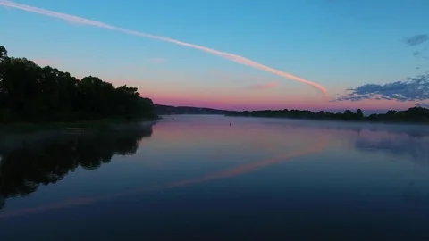 Flight over the river at dusk. Evening sky. ?alm surface of the river. Video stock 81729136