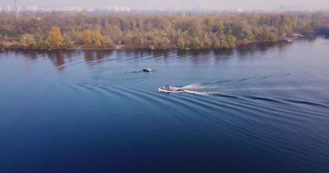 Flight over the river with floating boats with windsurfing and views of the Stock Footage 142225900