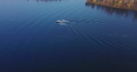 Flight over the river with floating boats with windsurfing and views of the Stock Footage 145255101