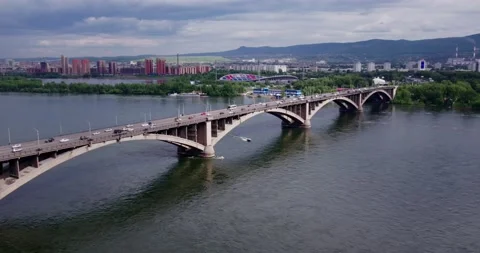 Flight over the river, road bridge, city and mountain view Stock Footage 171073634