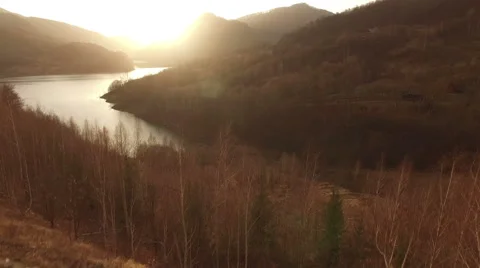 Flight over a river at sunset in mountain scene 動画素材 63017206