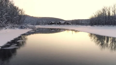 Flight over the river at sunset. Trees and mountains on the horizon are Stock-Footage 136943563