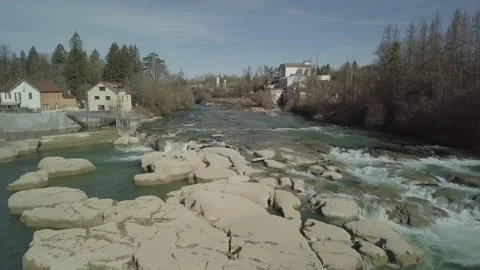 Flight over a river in winter small town 4k Stock Footage 148570110
