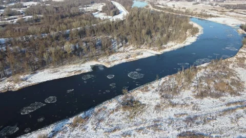 Flight over the river on a winter sunny day a moment after the water freezes. Stock Footage 167765420