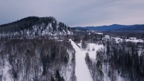 Flight over the road in in Altai mountains in winter Stock Footage 88475855