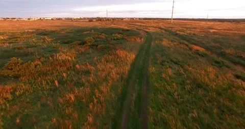Flight over the road in the field before sunset. Aerial view. rural landscape 動画素材 86825441
