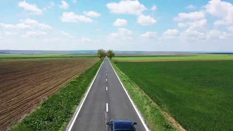 A flight over the road that goes through the fields Stock Footage 286948682