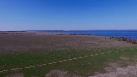 Flight over the road in the steppe. Panorama of the lake. Stock Footage 74725845