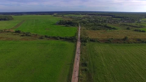 Flight over the road through the field. Aerial view. Stock-Footage 80232371