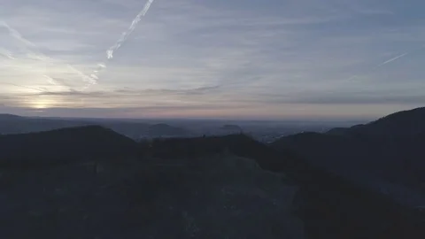 Flight over the rock mining complex revealing a colorful sunrise in the city, 4k Stock Footage 73795036
