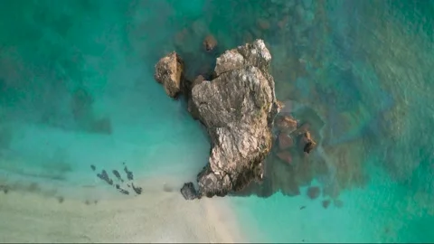 Flight over a rock in the sea Stock Footage 223235681