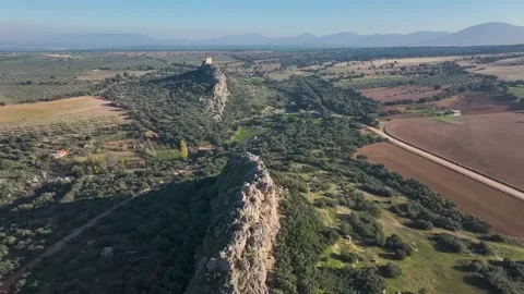 Flight over the rocks and the Castle of Dos Hermanas in Stock Footage 303570245