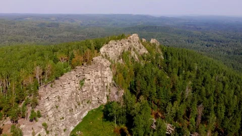 Flight over the rocks in the autumn forest. Drone flight from above. Red yellow Stockbeeldmateriaal 243259064