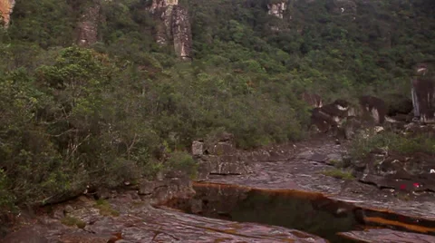 Flight over rocks, with red water and jungles Stock Footage 38710987