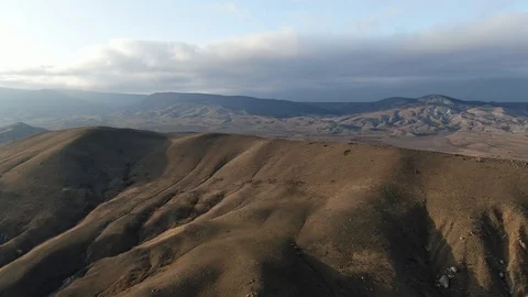 Flight over a rocky hill top view shooting using a quadrocopter Stock Footage 104909088
